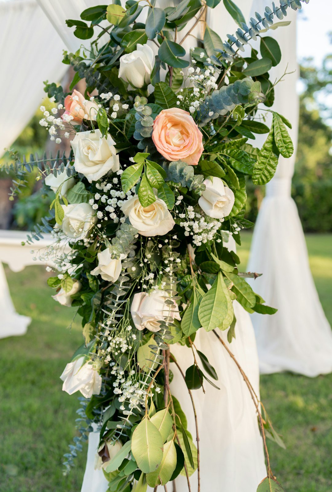 a-bride-holding-a-bouquet-of-flowers-and-greenery-idrt3rgujmq